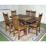 An oak draw leaf table and six dining chairs with barley twist legs
