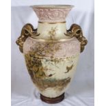 A large Victorian vase on a wood base.1