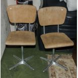 A pair of vintage chairs with metal bases, plywood seat and backs.