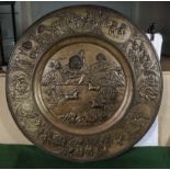 An antique Burmese embossed plaque depicting religious figures 79cm Diameter