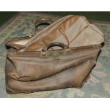 A large leather doctors bag and other leather items