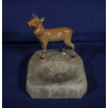 An onyx ashtray mounted with a cold painted bronze deer