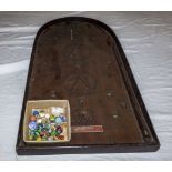 A vintage bagatelle game and marbles