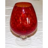 A large vintage red brandy goblet