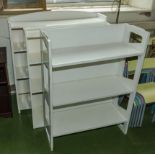 Three white painted open bookshelves