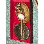 A 1920's dinner gong modelled as a mounted brass horses head in original leather case