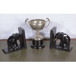 A pair of elephant book ends and a silver plate cup