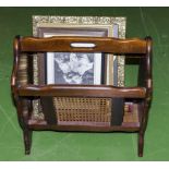 A magazine rack and a collection of framed prints