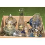 A box containing assorted oil lamps