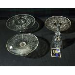 Three glass cake stands and a bell