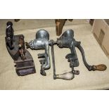 Two vintage mincers and two flat irons