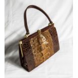 A vintage crocodile skin handbag