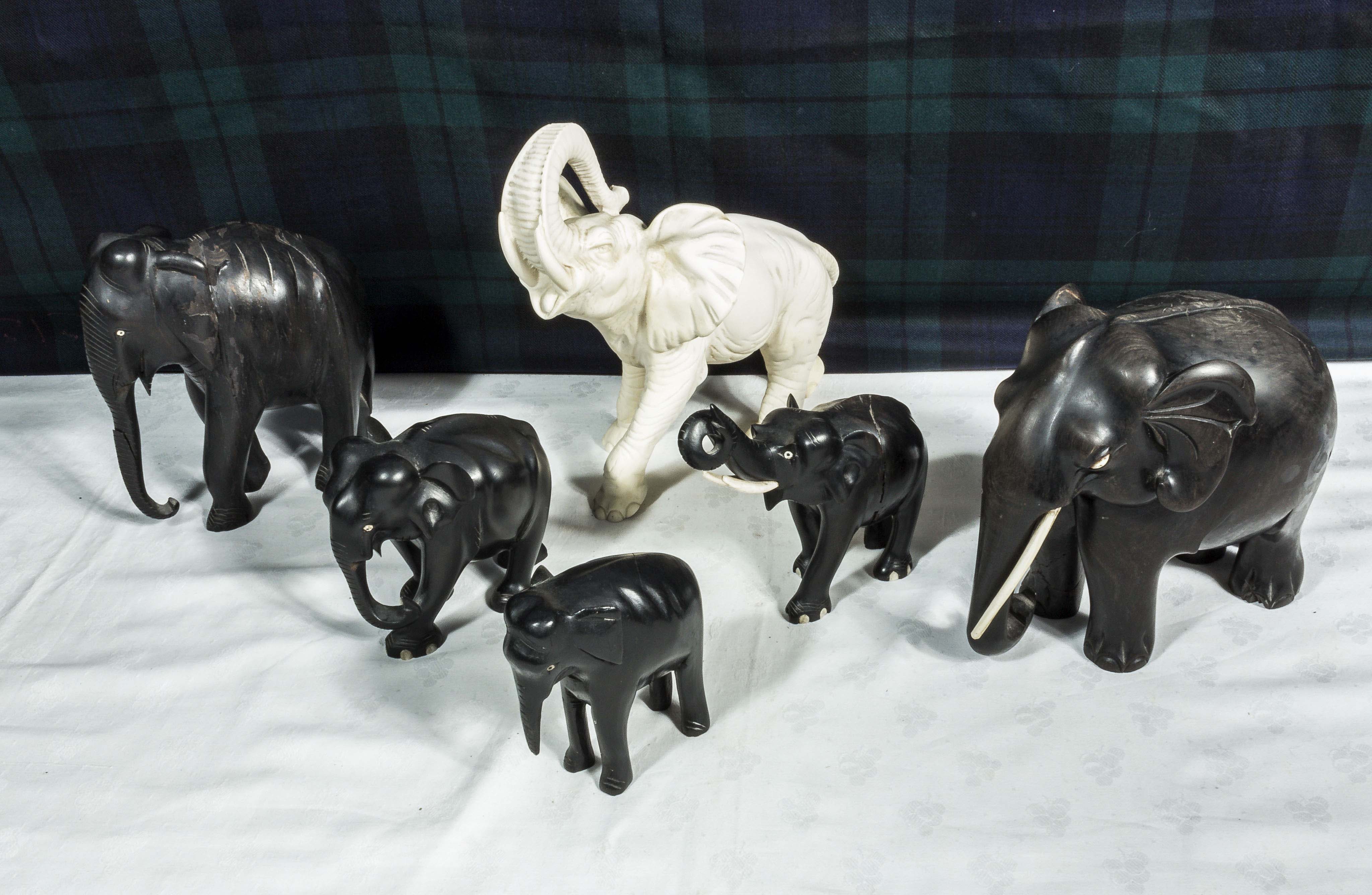 Six carved wooden elephants