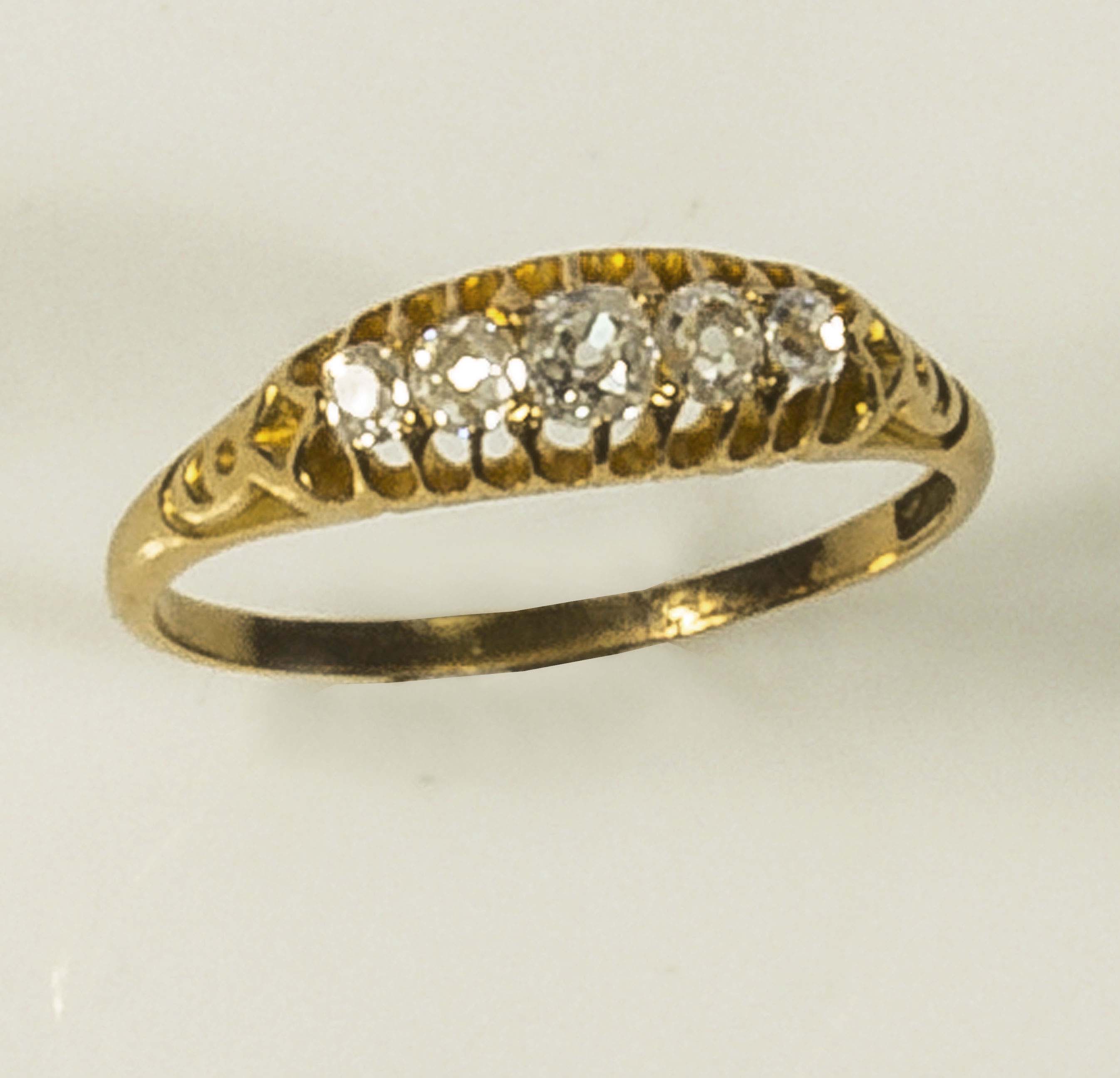 A lady's 18ct gold ring, gipsy set with five old cut diamonds