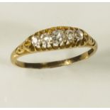 A lady's 18ct gold ring, gipsy set with five old cut diamonds
