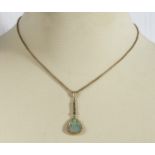 A 9ct gold pendant and chain set with an opal