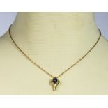 A 9ct gold chain and pendant set with a cabouchon sapphire