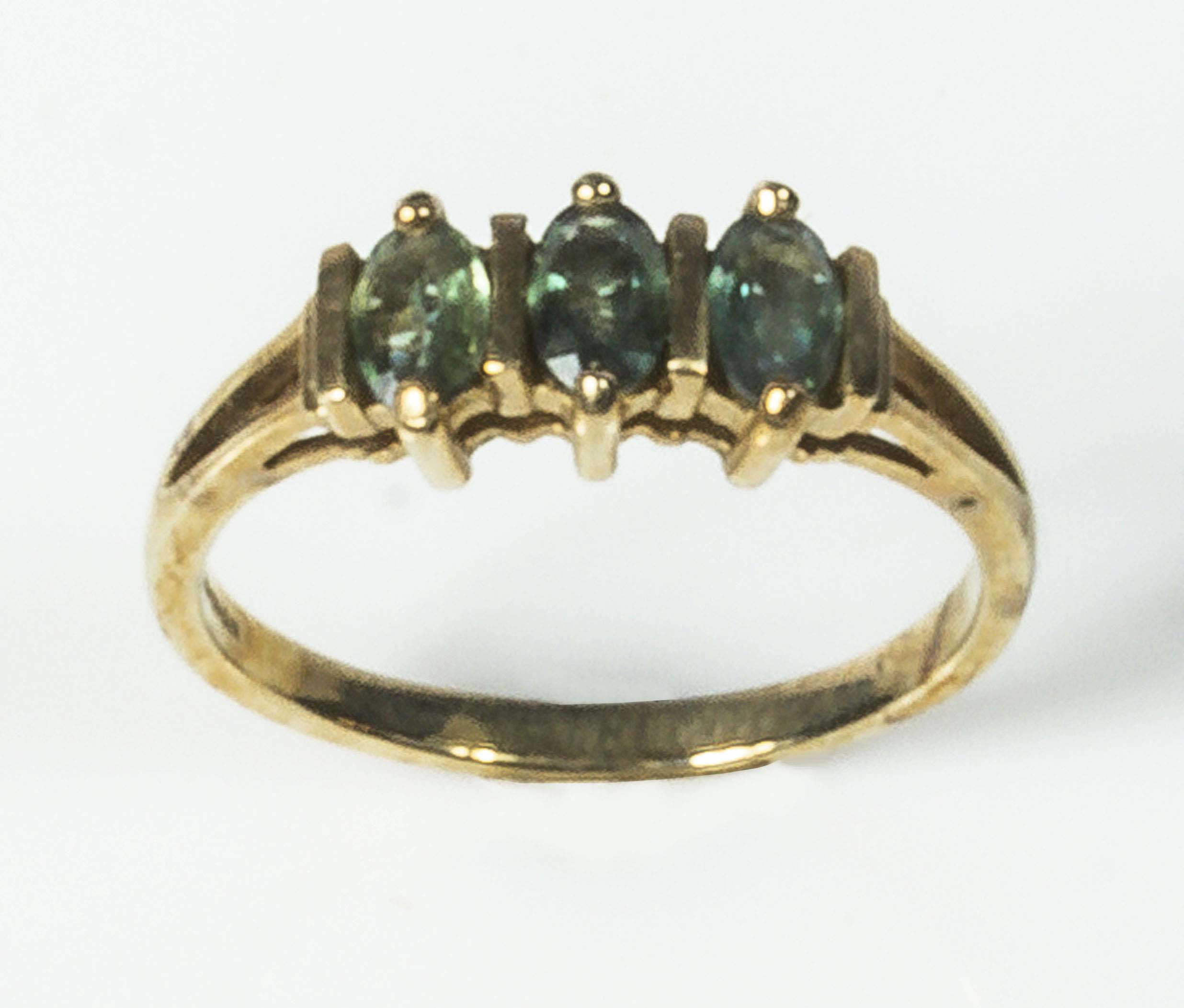 A lady's 9ct gold ring set with three tourmaline stones