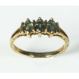 A lady's 9ct gold ring set with three tourmaline stones
