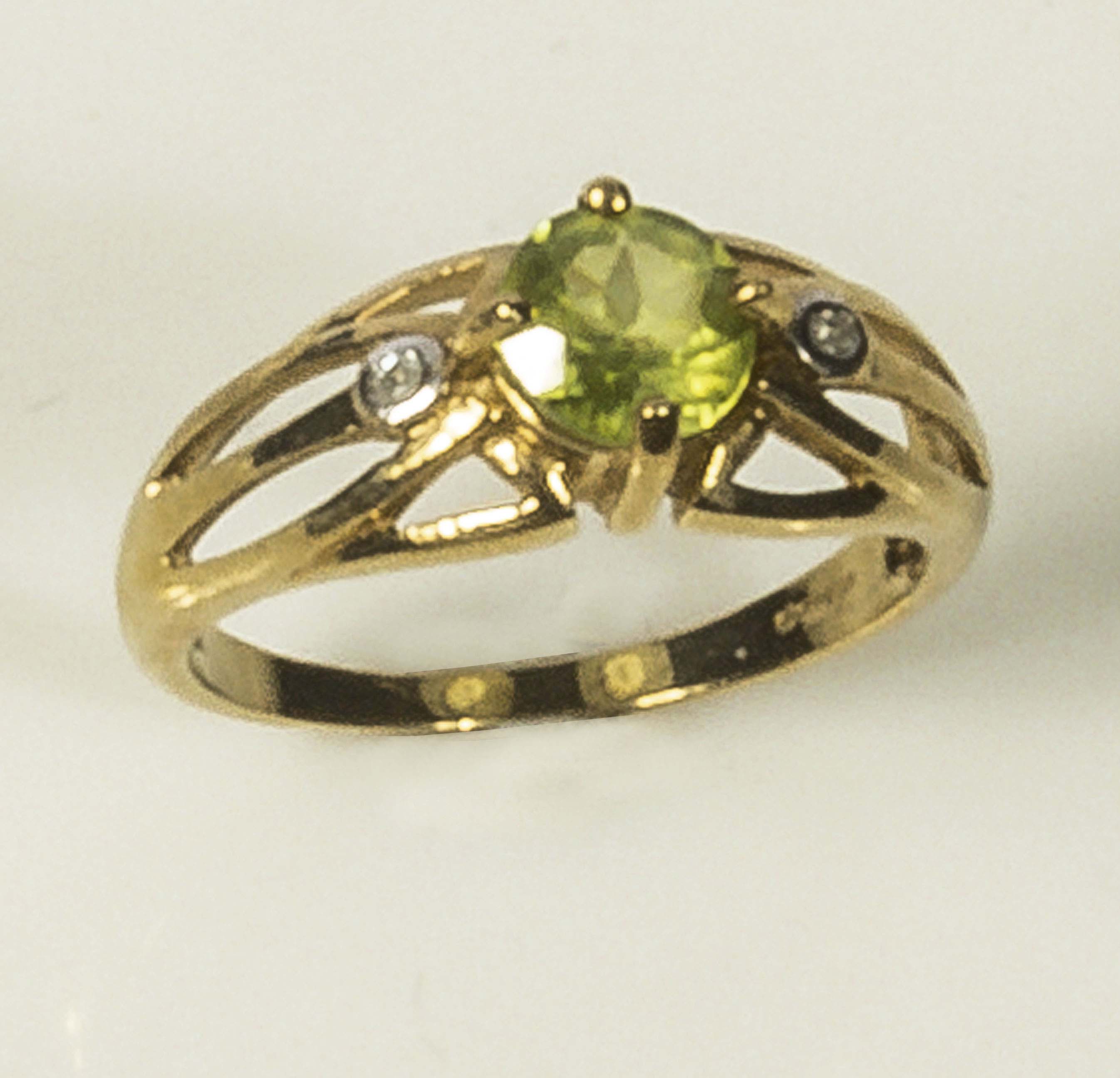 A lady's 9ct gold ring set with a peridot and diamonds