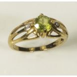 A lady's 9ct gold ring set with a peridot and diamonds