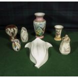 A pottery wall sconce and six vases