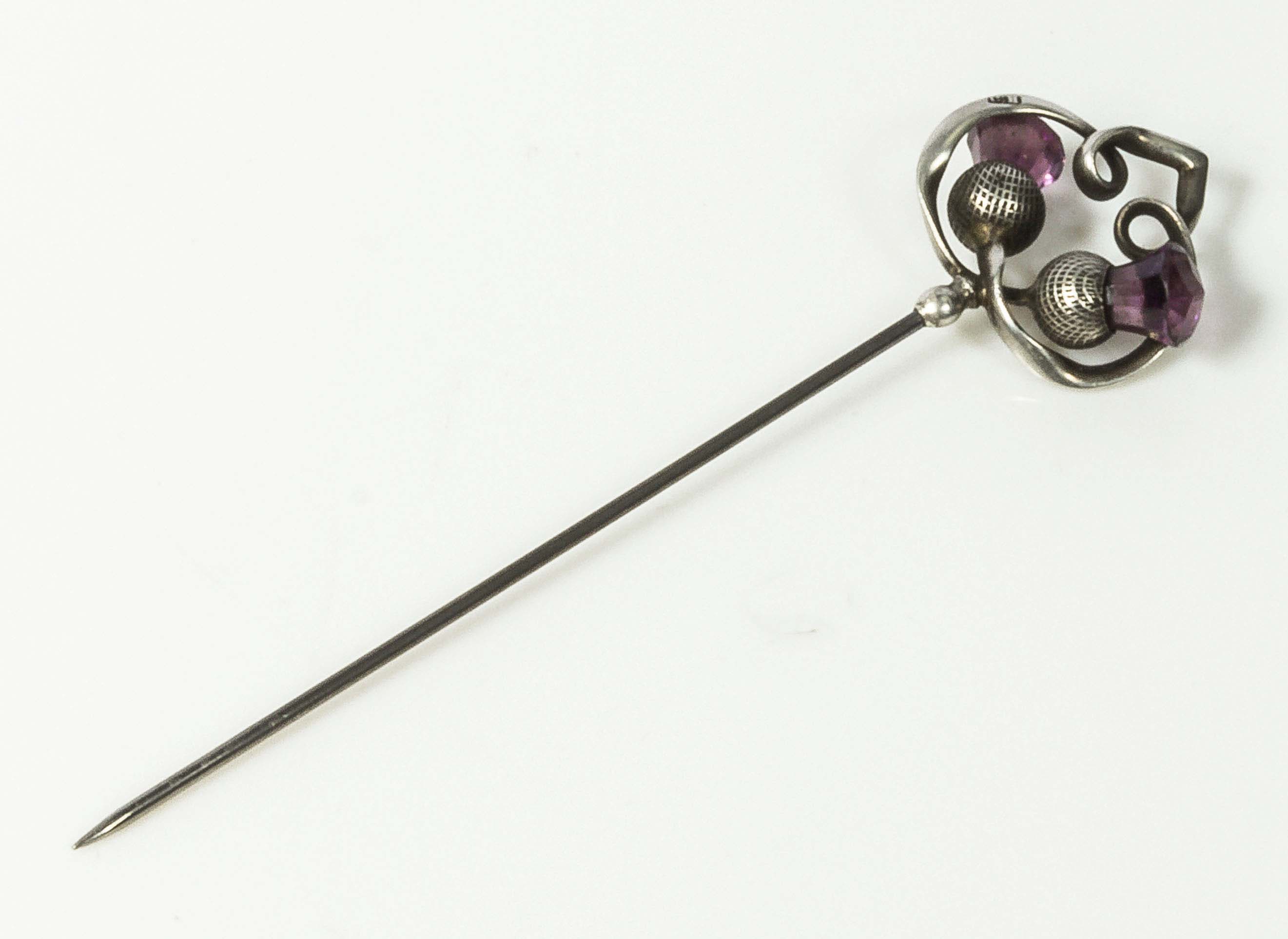 A Charles Horner Scottish thistle hat pin set with two amethyst