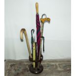 Stick stand with various walking sticks and umbrellas