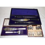 A cased carving set together with fish servers and teaspoons