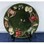 A large Portuguese Majolica charger with crabs and fruits of the sea, impressed marks to base,