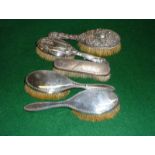 Five silver backed brushes