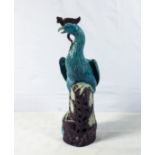 Large antique Chinese turquoise glazed peacock bird on aubergine glazed rocky base with flowers