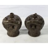 A pair of Bretby art pottery sculptured vases with a copper glazed body with ring handles