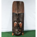 A carved wooden African style wall mask
