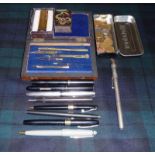A precision instrument set, fountain pens and other items
