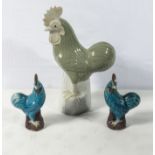 An antique Chinese Celadon glazed cockerel standing on a rock white glazed base 30cm tall together