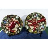 A pair of large Portuguese Majolica chargers with lobster, crab and muscle shell decoration, marks