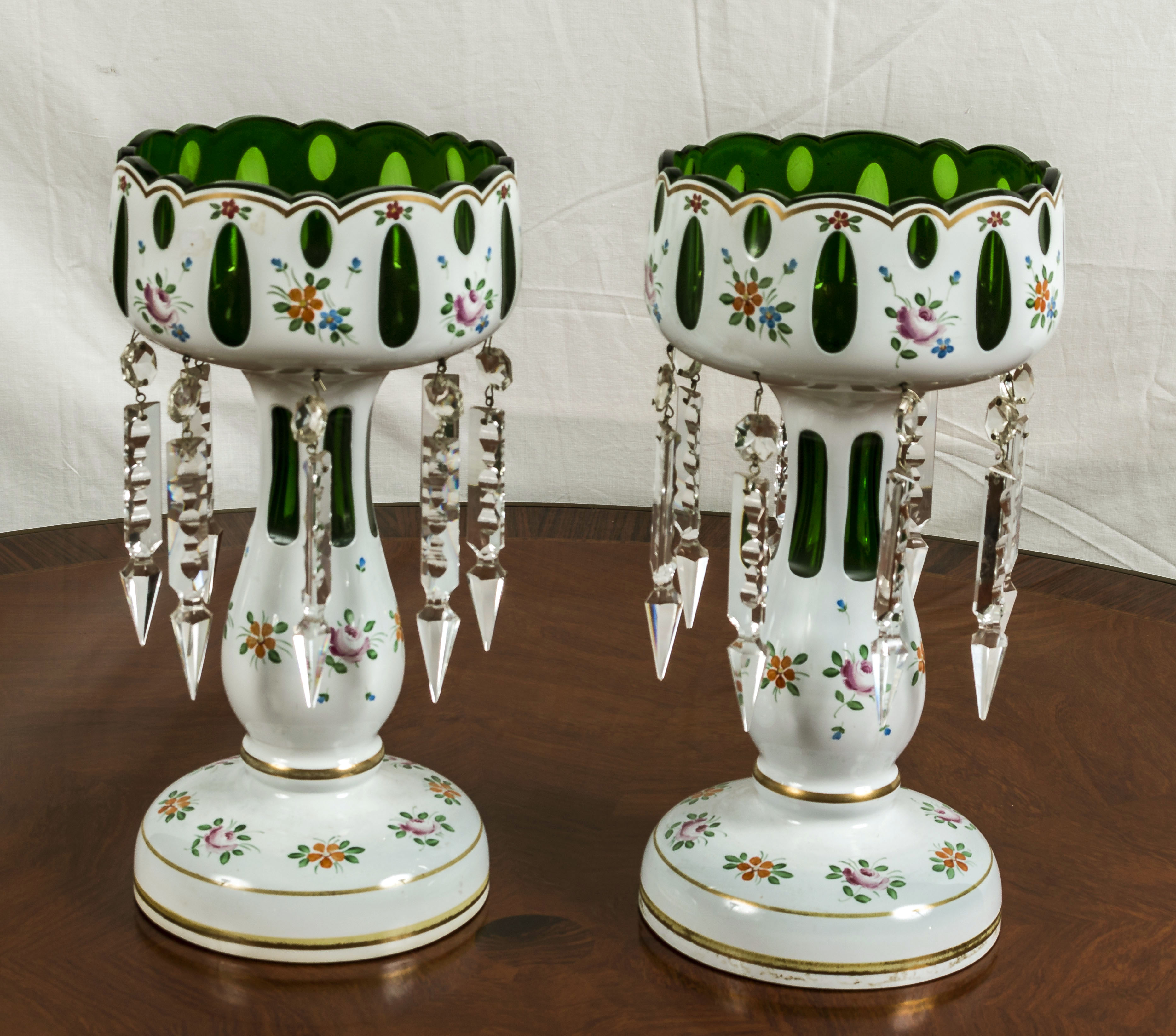 A pair of overlay glass lustres green glass with white overlay decorated with flowers.12inch high