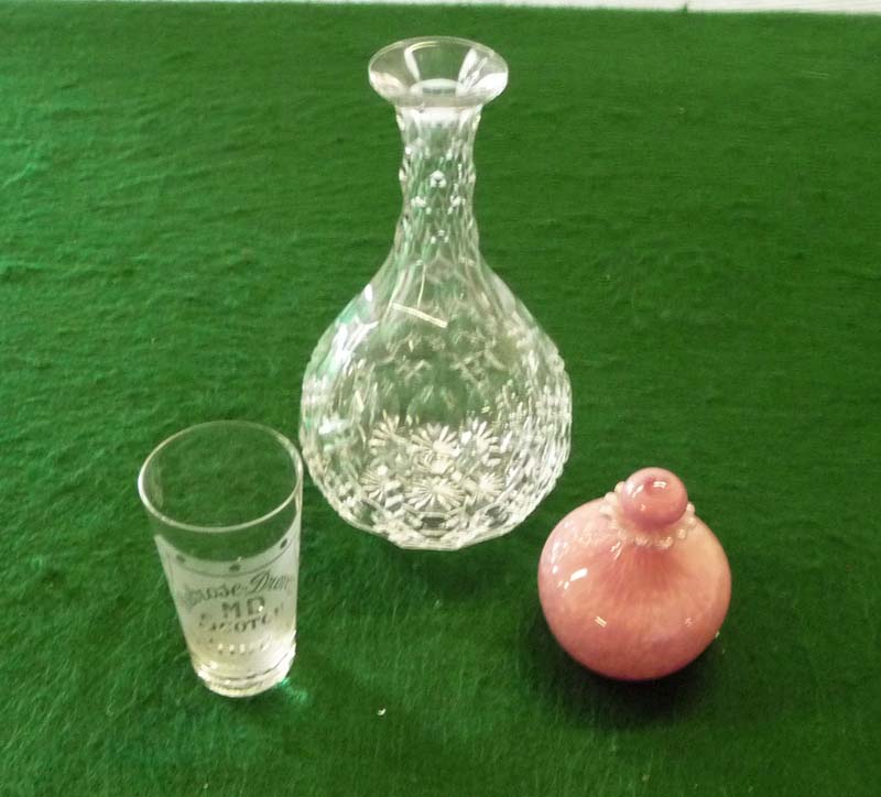 A crystal carafe and two others