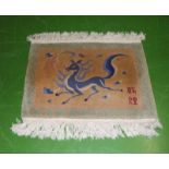 A vintage Chinese rug depicting a running horse with Chinese character marks