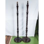 A near pair of barley twist wooden standard lamps