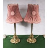 A pair of brass based table lamps and shades