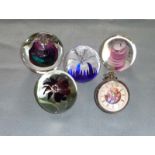 Five glass paperweights