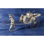 An antique Chinese silver three piece cruet depicting a figure pulling a rickshaw, character marks