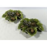 A pair of Bretby green glazed leaf pottery dishes decorated with walnuts and nut crackers,