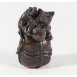 A Japanese netsuke two rats on a sack, signed