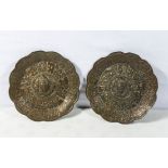 A pair of antique copper Tibetan dishes embossed with Buddhist symbols, 19cm diameter