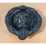 A cast iron lion head door knocker