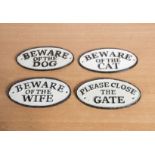 Four cast iron oval signs