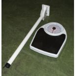 A set of bathroom scales and a folding arm